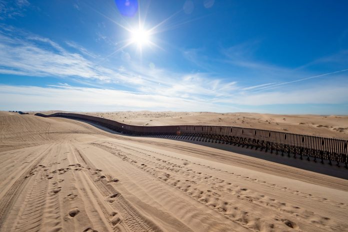 Border wall in the Imperial Sand Dunes, 20 miles west of Yuma, A