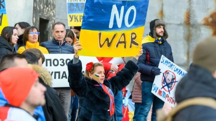 Em frente à sede da ONU, manifestantes protestam contra a invasão da Rússia à Ucrânia (Foto: Loey Felipe/ONU)