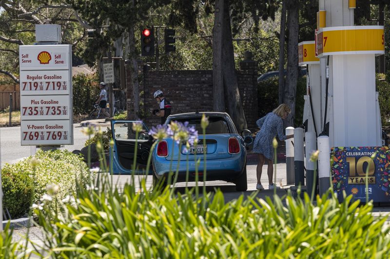 Consumidora abastece seu carro a $7.19 o galão de gasolina regular em um posto de combustível na Califórnia (Foto: David Paul Morris/Bloomberg)